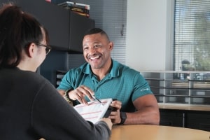 Administrator going over a class schedule with a student