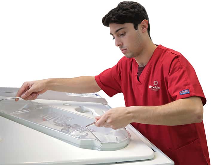 Sterile processing student getting hands-on practice with real equipment