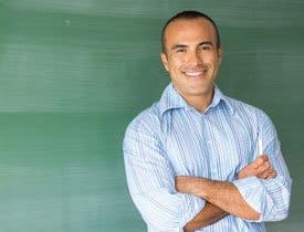 Smiling man with arms folded