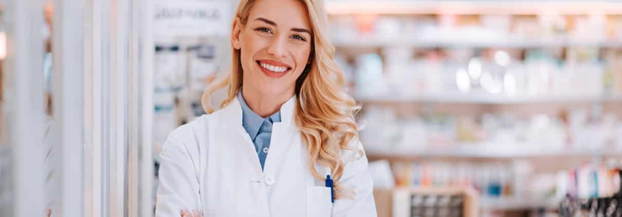 Smiling pharmacy technician at work
