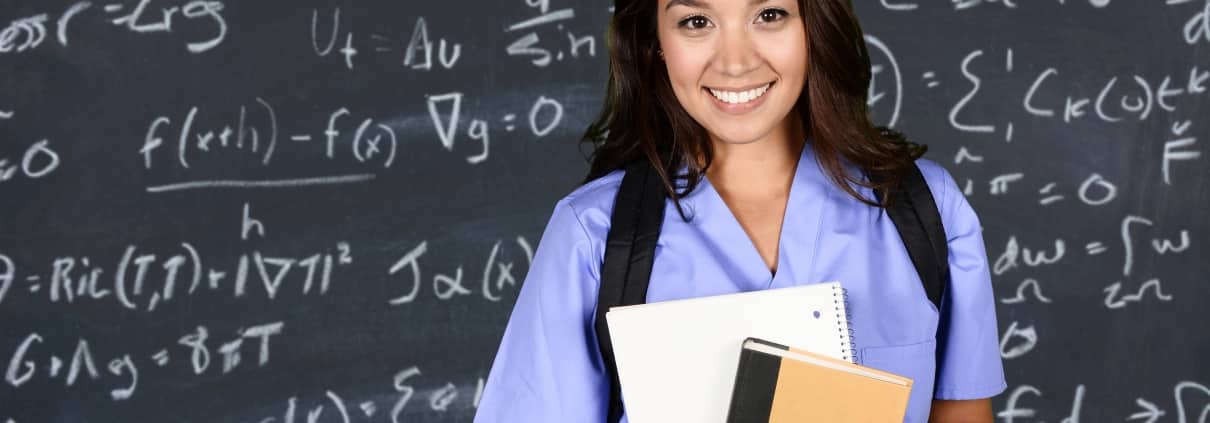 Medical student in front of a blackboard
