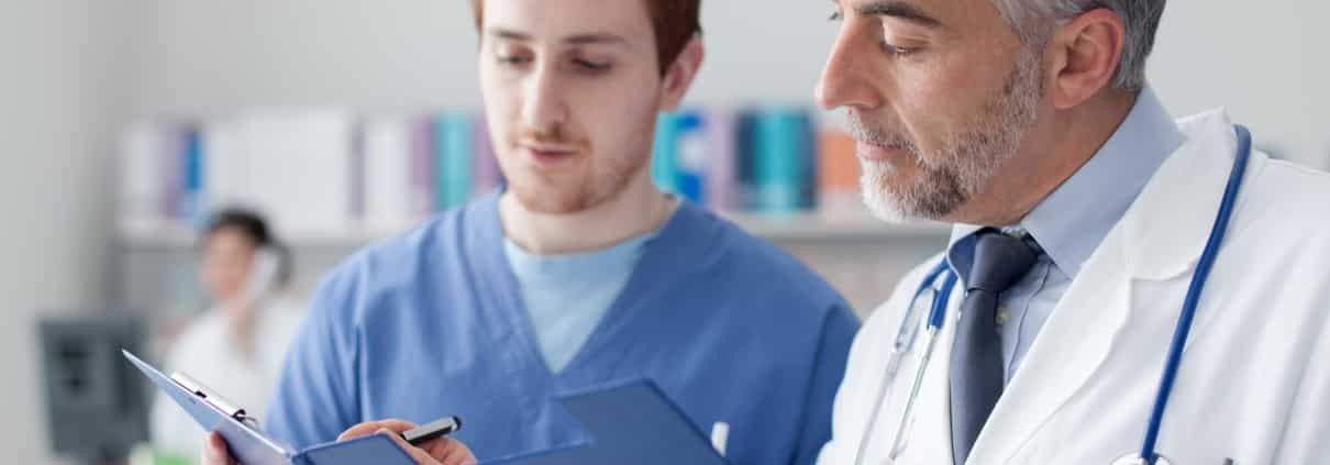 Doctor and nurse consulting a chart