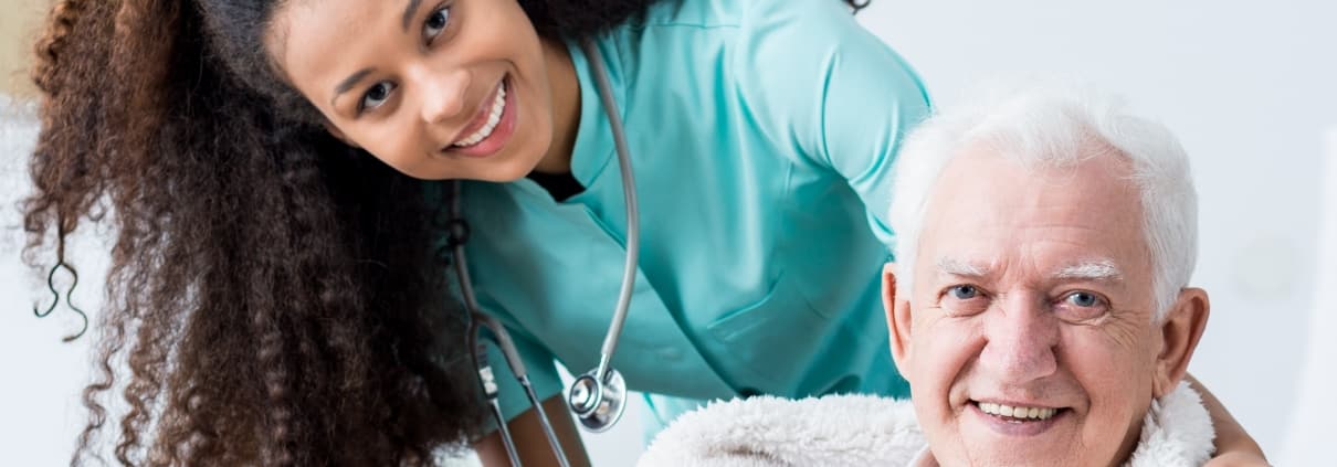 Smiling nurse with an elderly patient