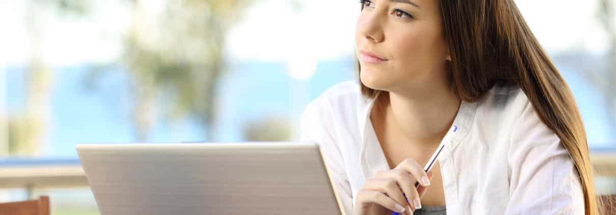 Woman with a pen and a laptop