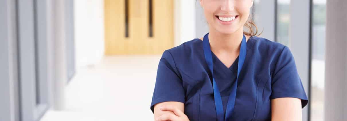 Smiling healthcare professional with arms crossed