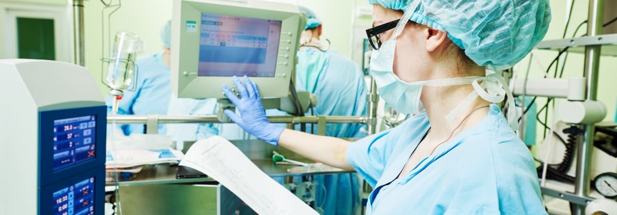 Surgical Technologist monitoring equipment