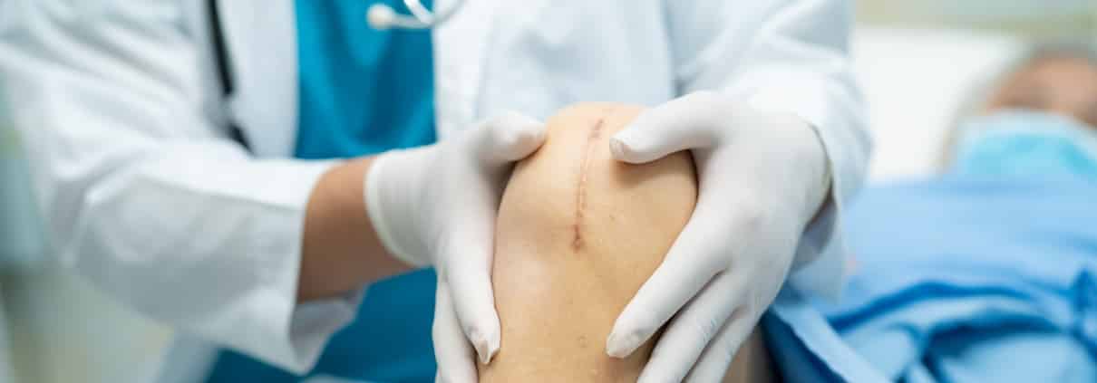 Healthcare professional examining stitches