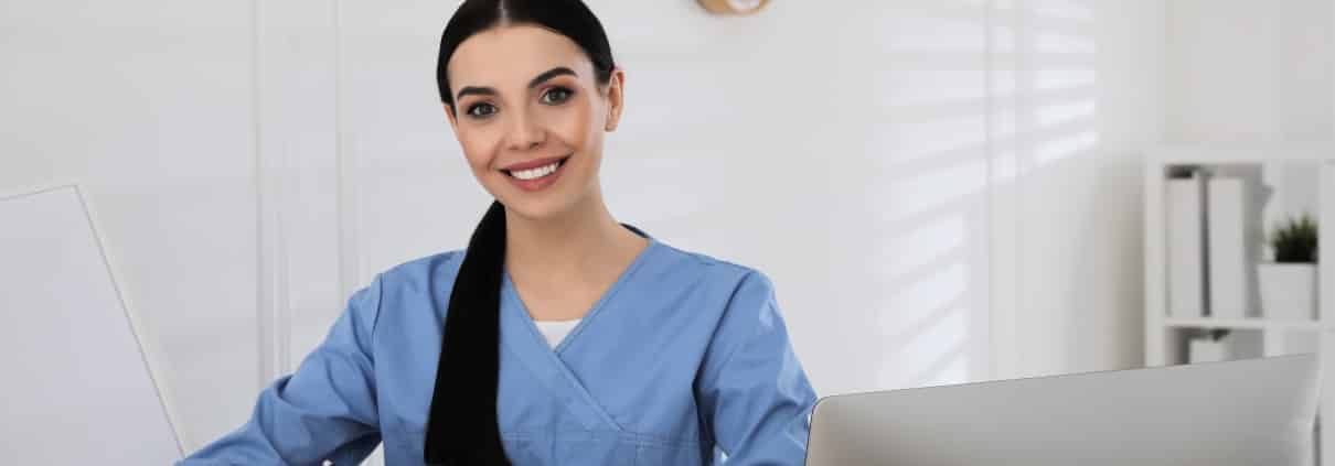 Young healthcare worker writing on a clipboard