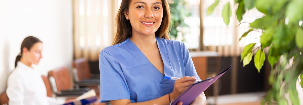 Confident nurse holding paperwork
