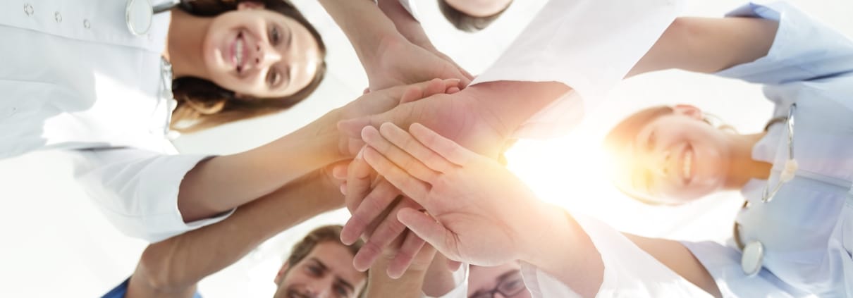 Medical team joining hands