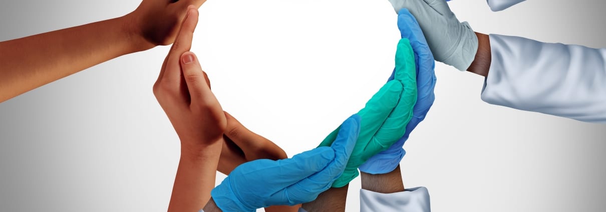 Healthcare workers forming a heart with their hands