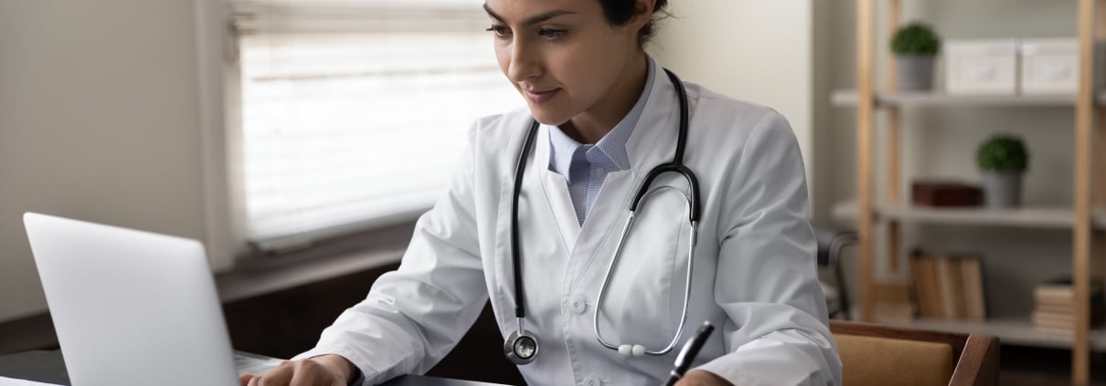 Serious young medical professional on a laptop