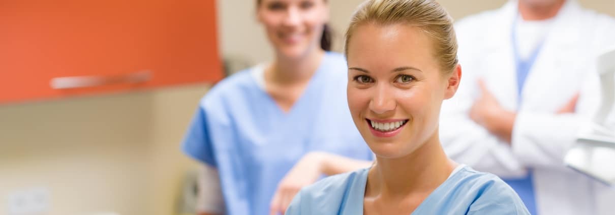 Group of smiling medical professionals in an exam room