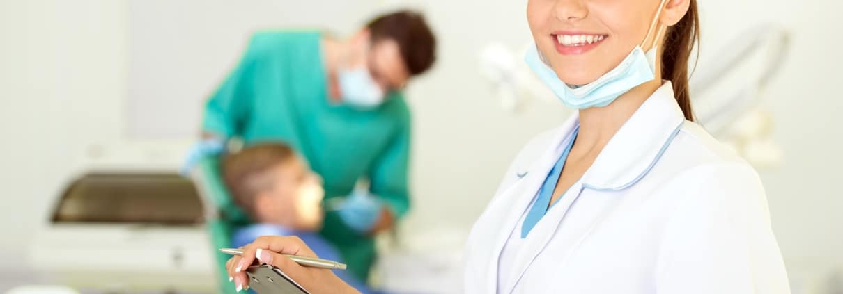 Close up of a dental professional with a clipboard