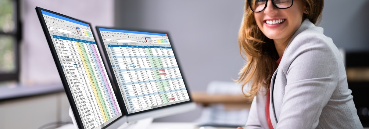 Smiling medical billing coder in front of a laptop