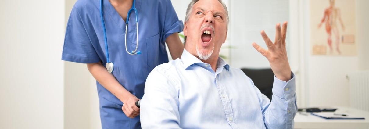 Female nurse with a disgruntled male patient