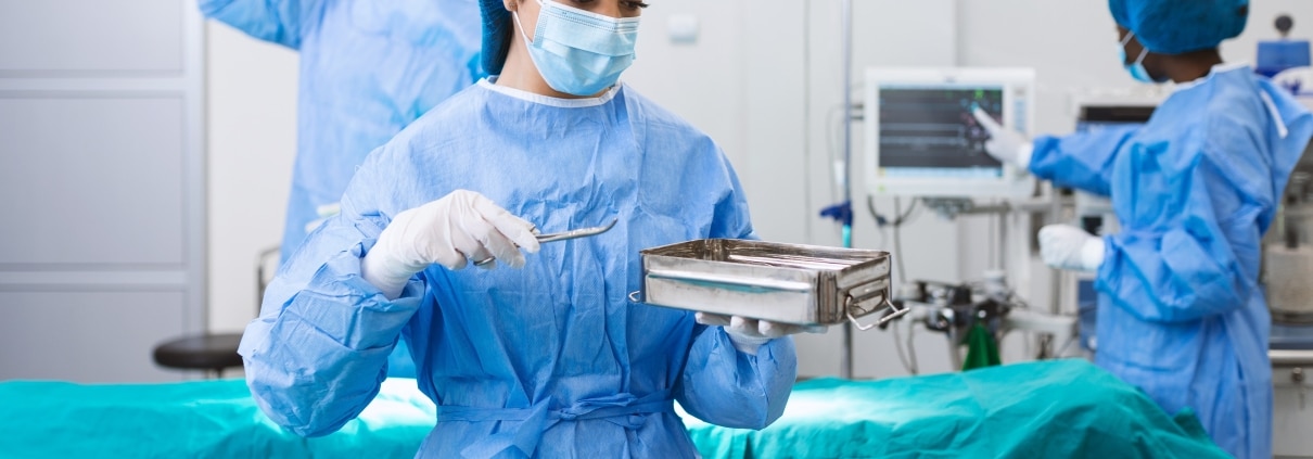 Surgical Technologist looking at equipment in the OR