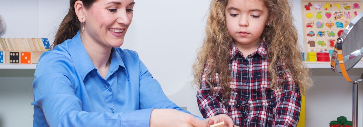 Occupational Therapy Assistant with a young child in a session