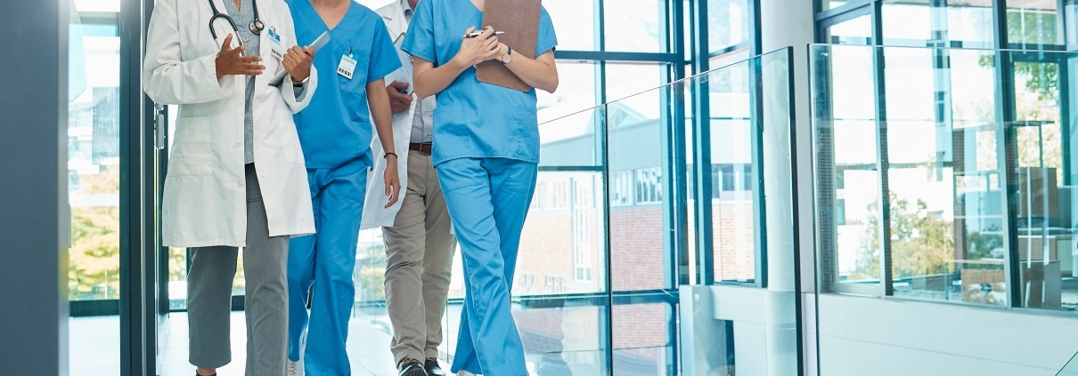Group of smiling medical professionals in a hallway
