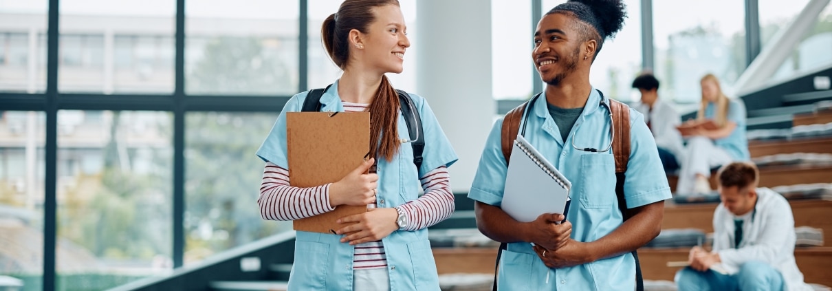 Two smiling medical students in a lecture hall