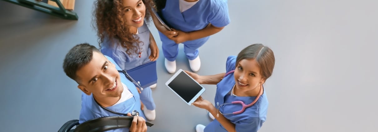 Overhead view of smiling medical students in a hallway