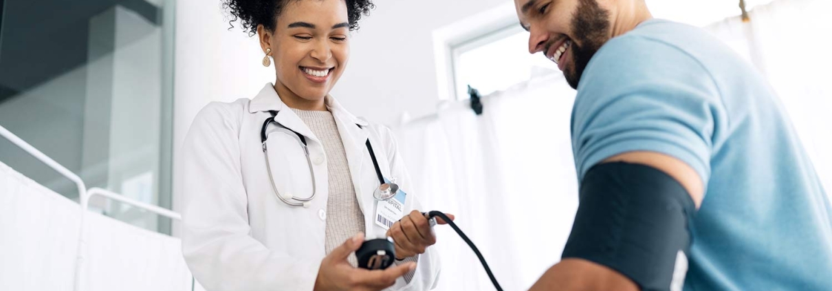 African-American doctor measuring a man's blood pressure