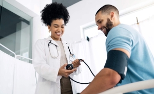 African-American doctor measuring a man's blood pressure